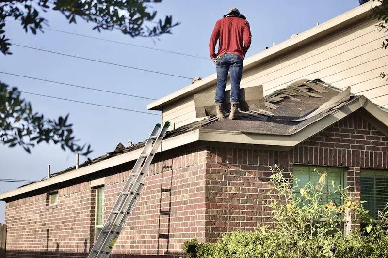 Professional roofer working on a residential roof in Stuart Creek Farms